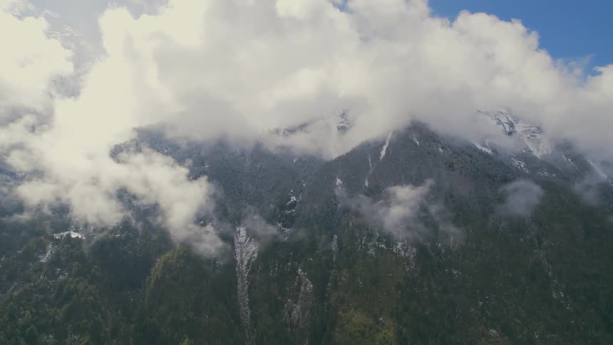 Clouds sit on the peak of the mountain