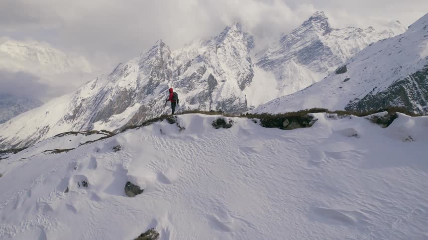 A person is hiking on the mountain top