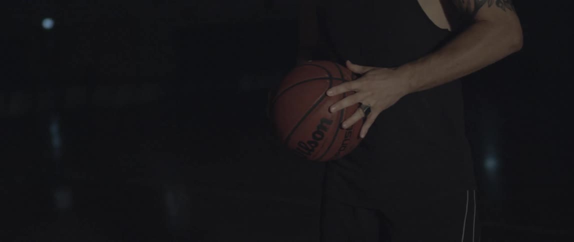 A man is spinning a basketball in his hands
