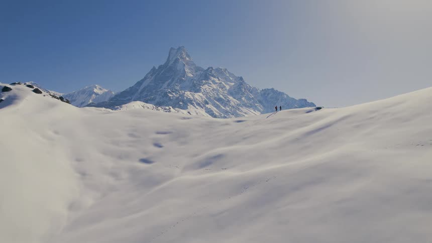 Hikers are traveling on the snow covered mountain