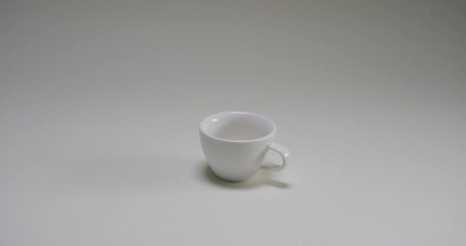 Tiny empty white coffee cup