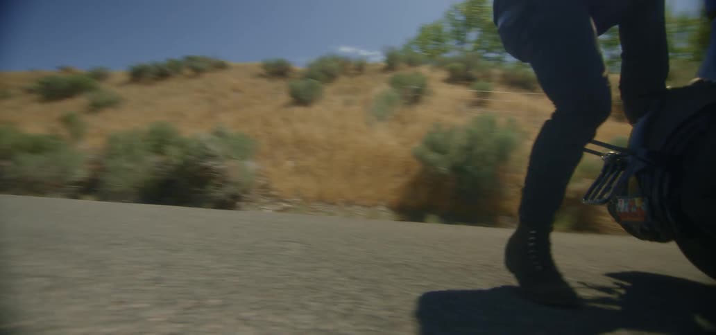 A motorcycle does a wheelie traveling by