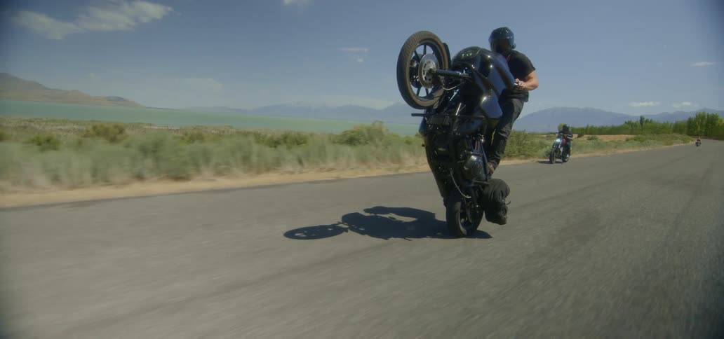 Man does a wheelie riding a motorcycle