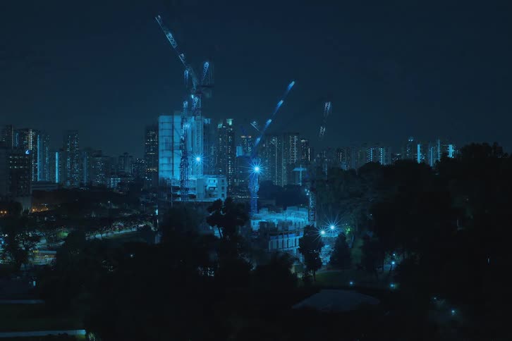 Time lapse of skyscrapers construction at night in the city