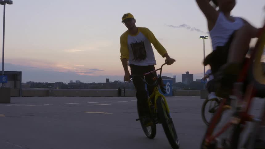 Group of teenager boys riding bicycles during dusk or dawn