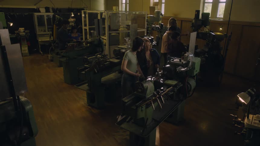 Several people work in pairs as they operate various pieces of machinery