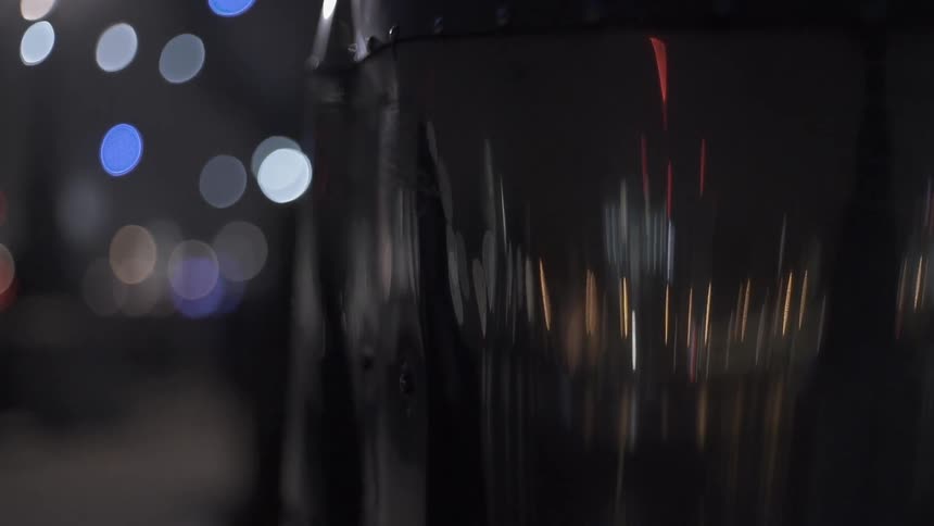 A metal container is reflecting the lights around it