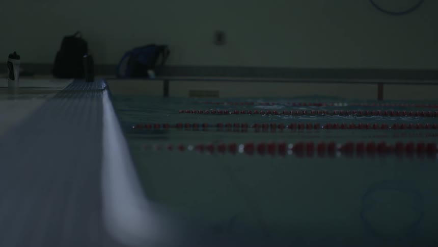 Athletes swimming on an indoors olympic pool