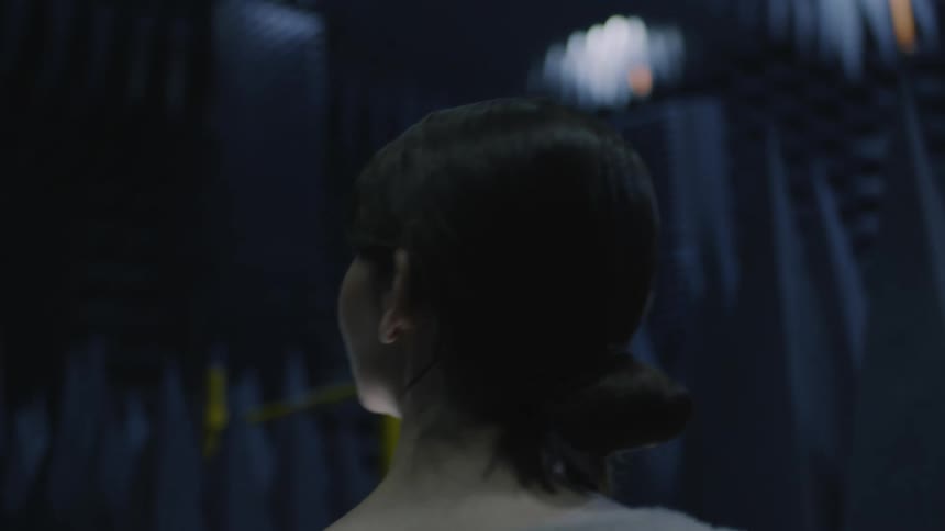 Two women walk through a facility that has soundreduction foam on the walls