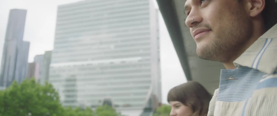 A group of people outside looking at buildings