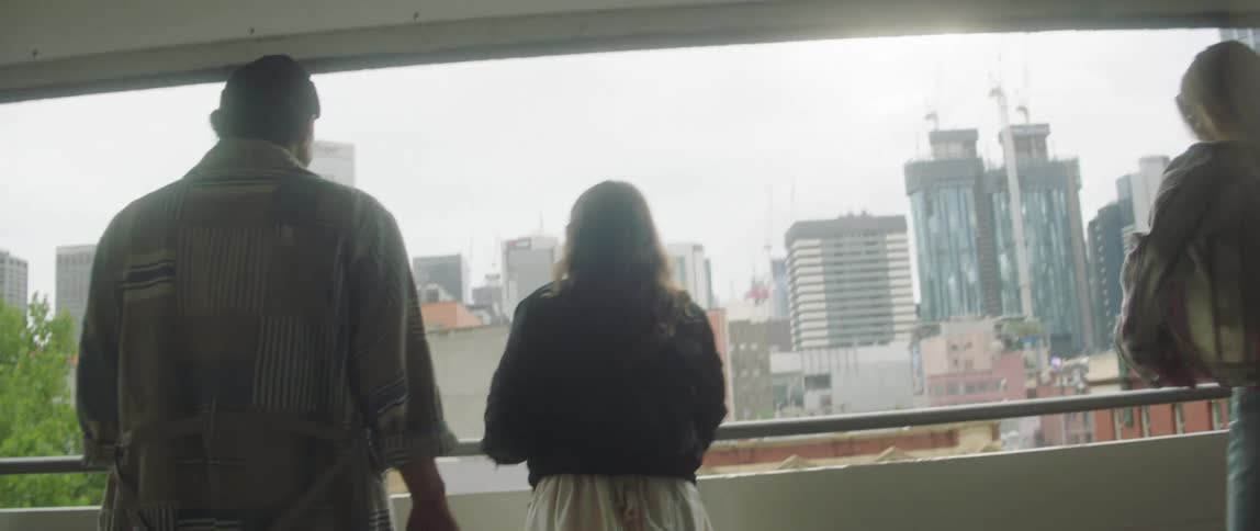 People walk towards the railing in the parking garage