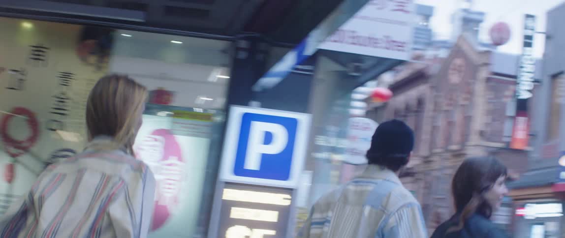 A group of people cross the street