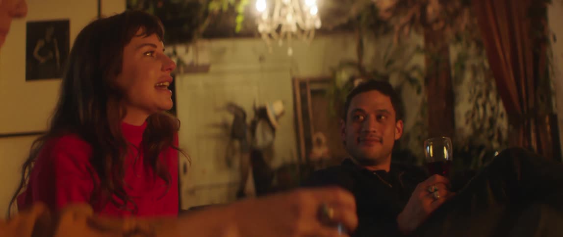 A man and woman drinking in a room