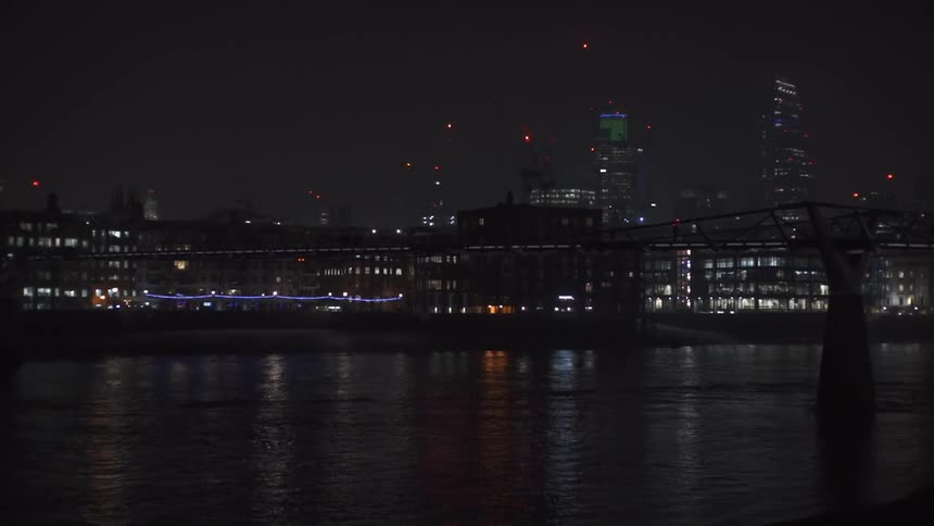 Water ripples in front of a nighttime cityscape