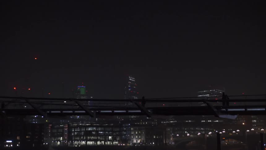 The city is lit at night in the distance