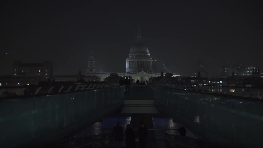 Water leads to some large buildings at night