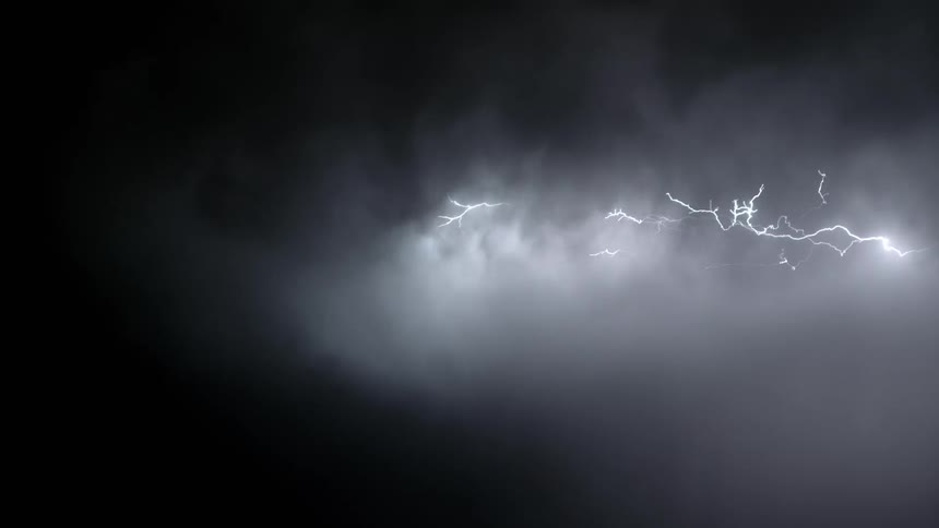 Streaks of lightning spread throughout a stormy sky at night