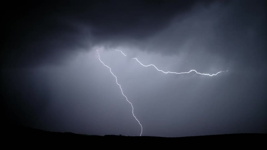 A heavy lightning storm cutting through the night sky