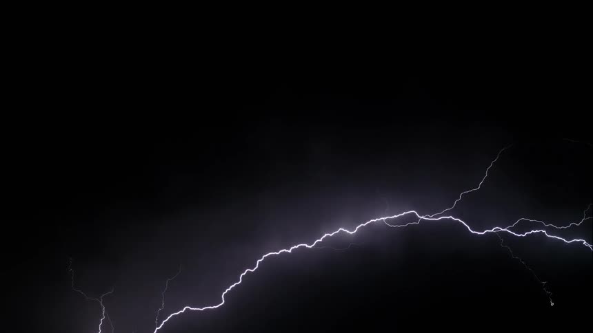 A heavy lightning storm cutting through the night sky in slow motion