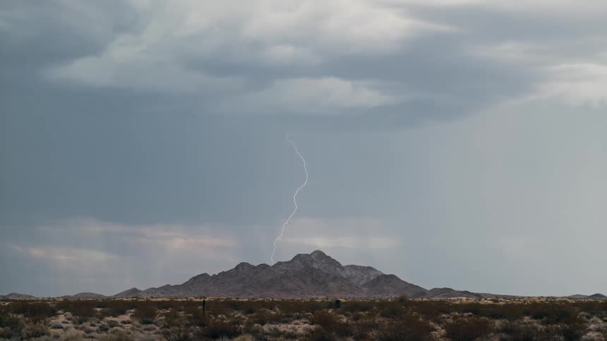 Wide natural landscape with a mountain under a thunderstorm