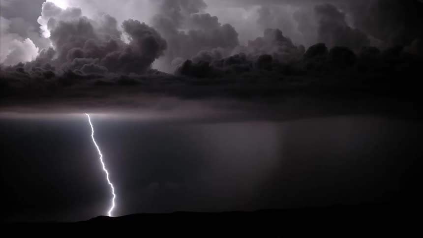 Bolts of lightning illuminate the dark sky at night