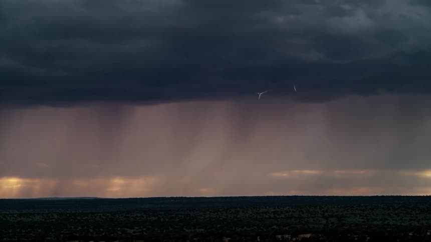 Lightning cutting through the sky and hitting a plain below