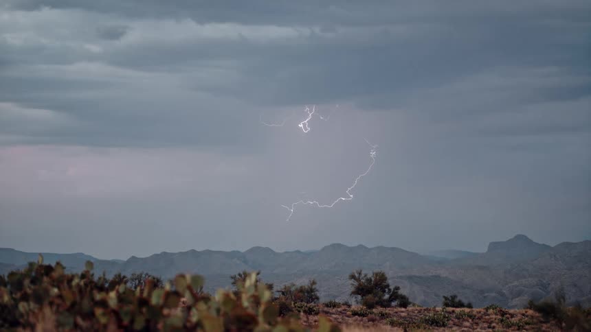 Lightning strike over the mountains in the desert
