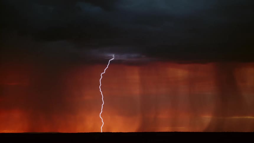 Several bolts of lightning descend from dark storm clouds above