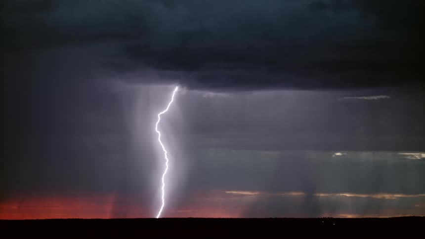 Thunder storm at sunset with clouds of smoke