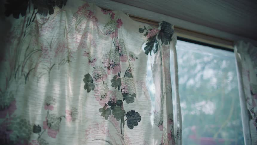 Close up of floral curtains in room