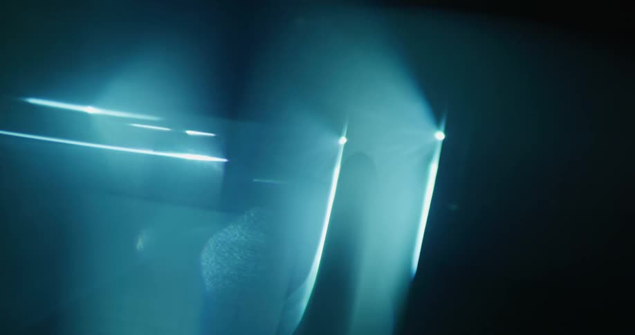 Abstract female silhouette dancing under blue lights