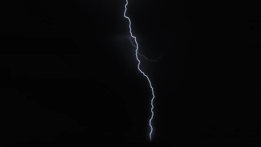A lightning storm at night lighting up the dark sky cracking down toward the ground