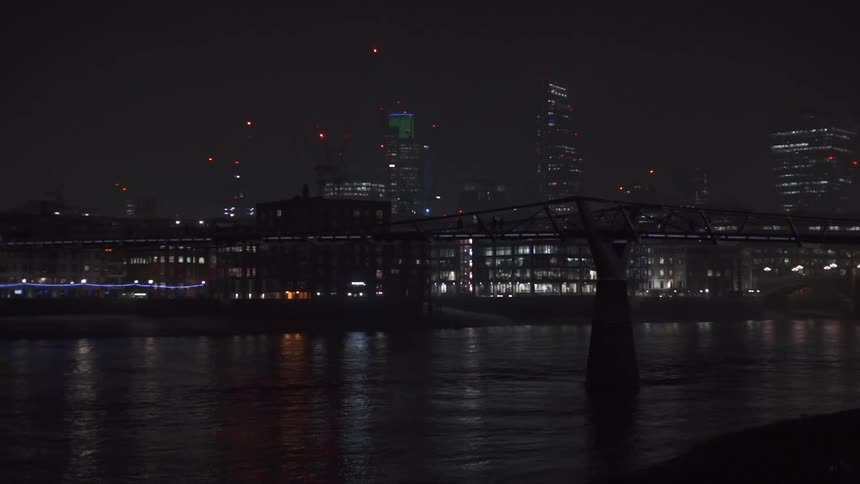 A bridge and city skyline at night