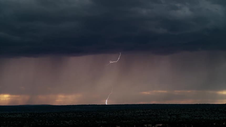 A storm is shooting lightning and rain ahead