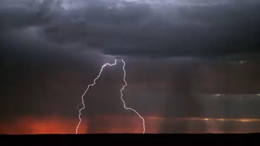 Rain and lightning falling over the plains at evening