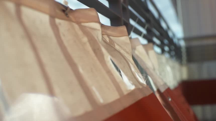 Red and white curtains blowing in the breeze