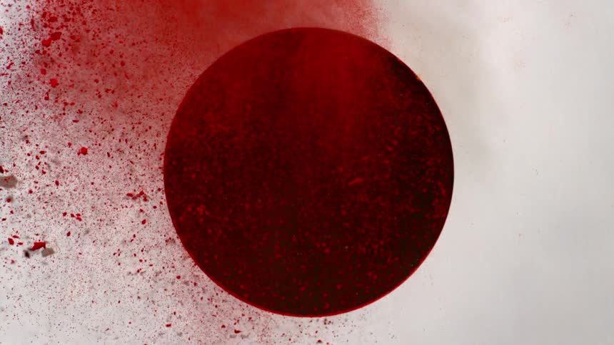 Yellow and red powder a shot through a dark circle