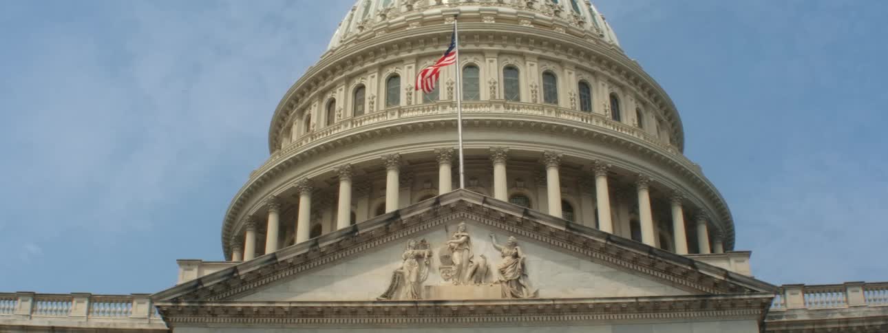 The flag flies above the building