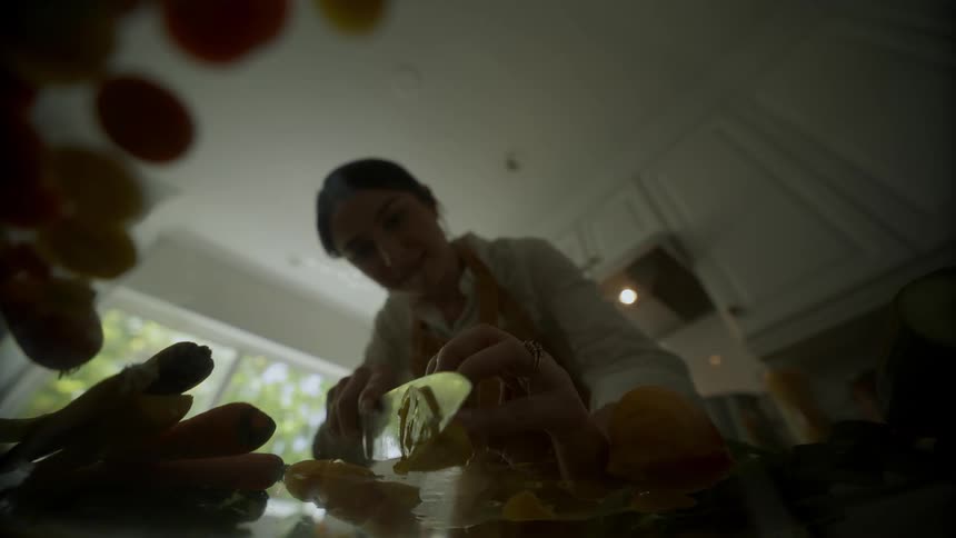 Woman holding a knife and cutting food