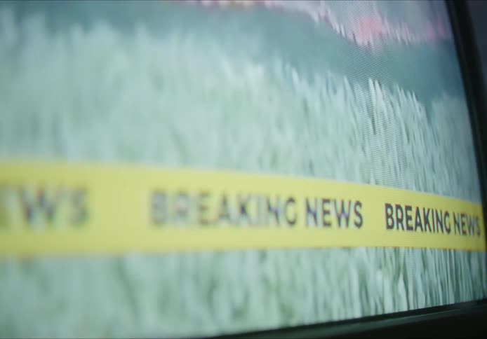 A screen where a forest is being burned and being reported on television