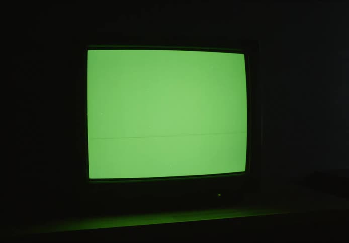 A tv showing green screen and then loosing its signal in a dark room