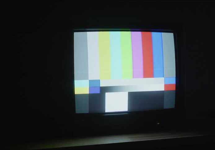 Gray scale blocks on television end in colored bar test pattern