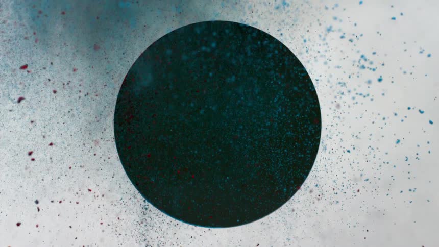 Blue and red dirt fly from a circle