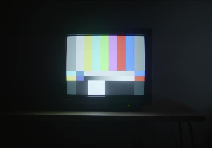 A screen with colorful stripes and a granulated black and white screen after