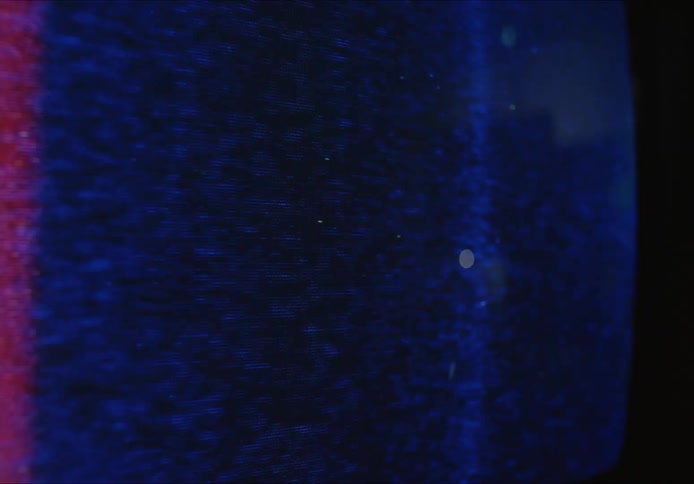 A bright screen changing colors with pixels bouncing around on the screen
