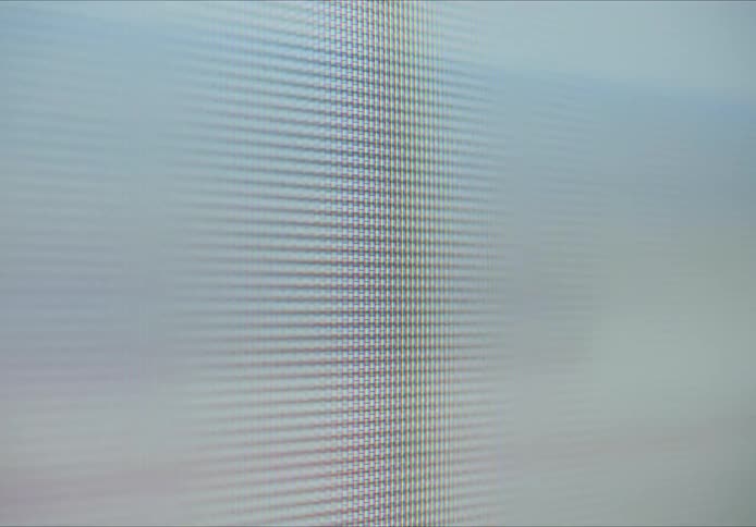 A glossy screen full of colored pixels forming some high zoom image