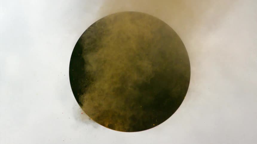 Orange powder flies through an opening