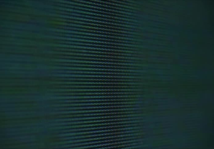 Close up of a television screen with static and pixels on it