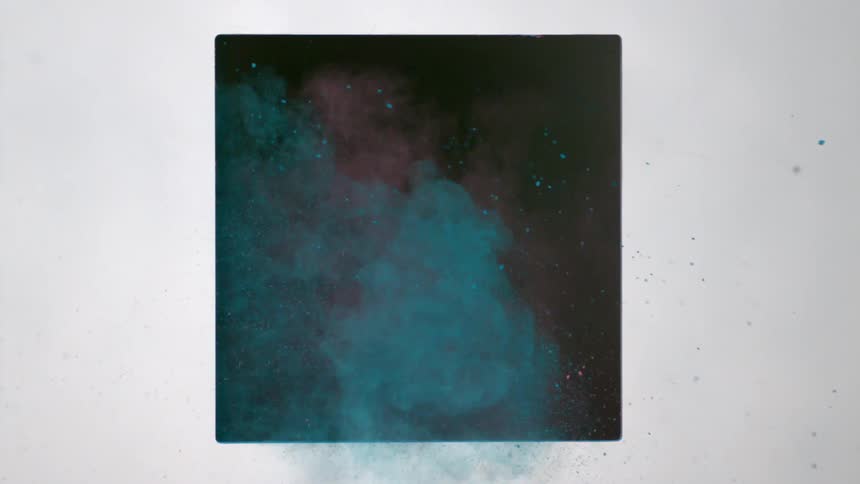 Pink and blue powder shooting through a square hole in wall