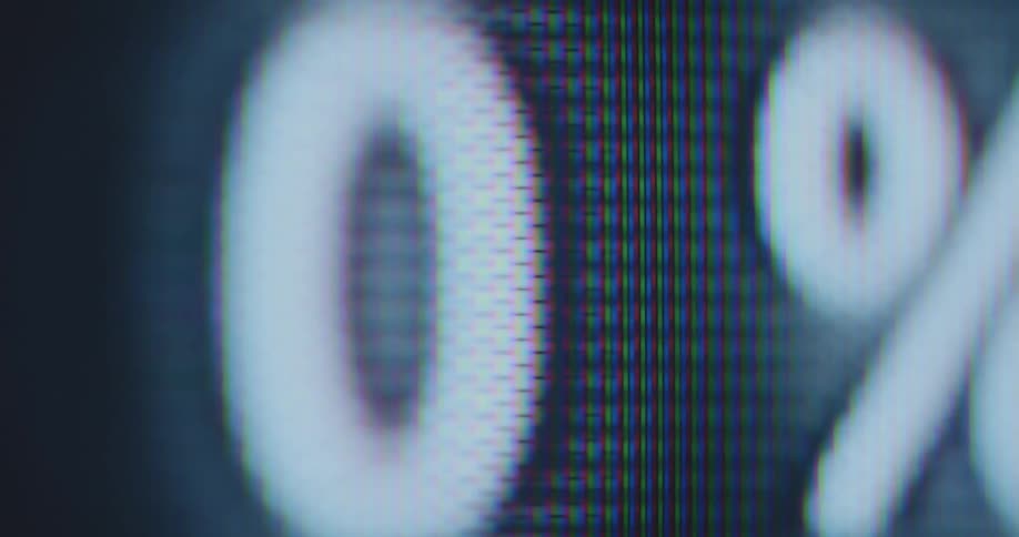 Shaky handheld extreme macro shot of black numbers or digits counted in percent or percentage goes up and down while rising and falling and changing color to white symbolizing downloading uploading or scanning process